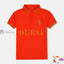 An orange polo shirt with gold embroidered text 'Dubai' on the chest and a visible brand logo on the right chest area.