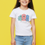 Child wearing a white t-shirt with colorful house design on a yellow background