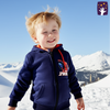 Child wearing a Spider-Man hoodie in a snowy landscape with mountains in the background