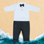 A baby boy's outfit set with a grey pant and a white shirt with bow tie, displayed against a beach-themed backdrop.
