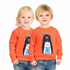 Two children wearing matching orange sweatshirts with bear graphics on a white background