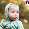 Baby wearing a light blue hoodie with animal patterns outdoors