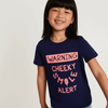 Child wearing a navy blue t-shirt with pink text on a white background