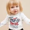 Child wearing a white long-sleeve shirt with a motorcycle graphic and text on a light gray background.