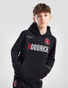 Person wearing a black tracksuit with 'Goodrich' branding on a white background