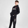 Person wearing a black tracksuit with 'Goodrich' branding on a white background