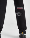 Person wearing a black tracksuit with 'Goodrich' branding on a white background