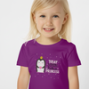 Child wearing a purple t-shirt with a penguin graphic and text on a white background
