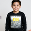 Child wearing a black sweatshirt with 'City of All Dreams NYC' design on a light gray background