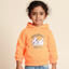 Child wearing an orange hoodie with a cat graphic and text on a beige background