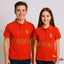 Two people wearing red polo shirts with 'London' text and a logo on a plain background