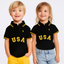 Two children wearing black polos with 'USA' text on a white background