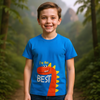 Child wearing a blue t-shirt with a dinosaur graphic and text, standing in a forest setting.