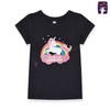 Child wearing a black t-shirt with a unicorn graphic and text on a beige background