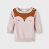 Baby wearing a pink sweater with a fox design on a white background