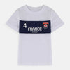 Child wearing a white t-shirt with '4 France' printed on it against a beige background