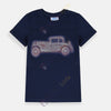 Child wearing a navy blue t-shirt with a vintage car design on a plain background