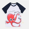 Child wearing a shirt with an octopus design and text on a beige background