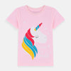 Young girl wearing a pink t-shirt with a unicorn design on a plain background