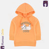 Child wearing an orange hoodie with a cat graphic and text on a beige background