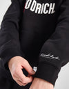 Person wearing a black tracksuit with 'Goodrich' branding on a white background
