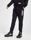 Person wearing a black tracksuit with 'Goodrich' branding on a white background