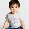 Child wearing a gray t-shirt with colorful fish design on a plain background
